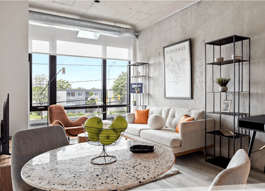 A modern living room with a large window and a flat screen TV.