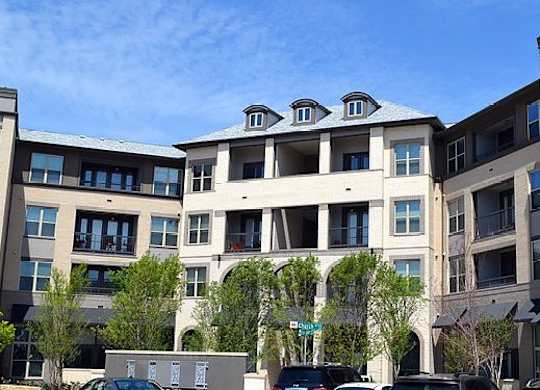 Building with balconies and a sidewalk at Civic at Frisco Square Apartments, Frisco, Texas