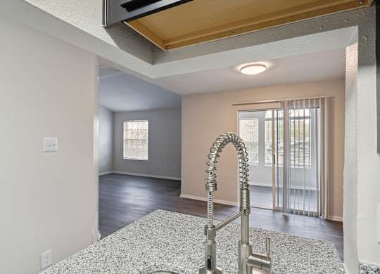 A kitchen with a sink and a window.
