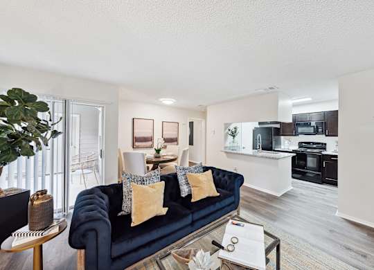 A living room with a blue couch and a coffee table.