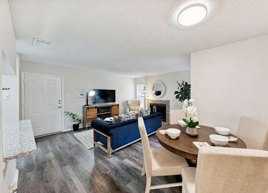 A living room with a blue couch and a wooden table.