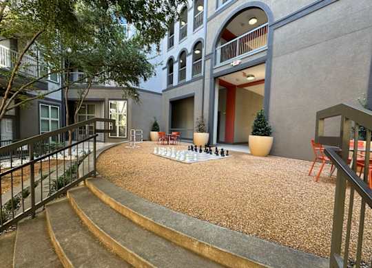 Courtyard with a chess board and chairs at Civic at Frisco Square Apartments, Frisco, TX, Texas