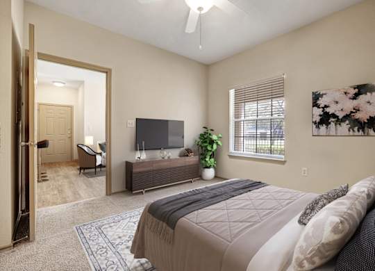 A bedroom with a large bed and a flat screen TV.