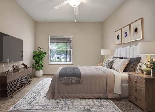 A bedroom with a bed, dresser, and ceiling fan.