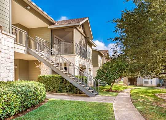 A residential building with a staircase leading to the entrance.