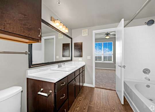 A bathroom with a white tub and sink.