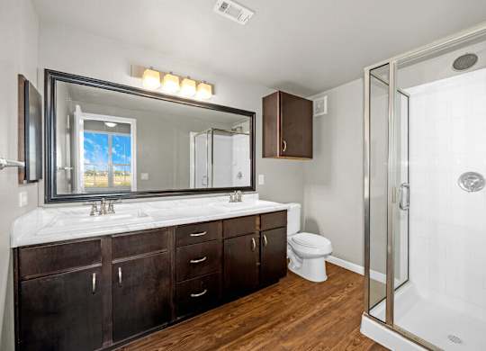 A bathroom with a white tub and a large mirror.