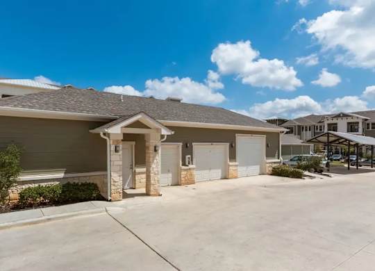 A house with a brown roof and a white garage door.