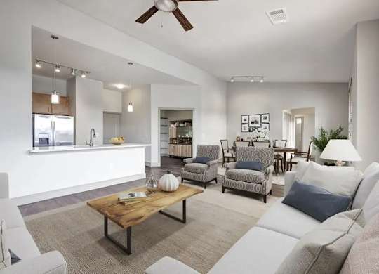 A living room with a white couch, a wooden coffee table, and a ceiling fan.