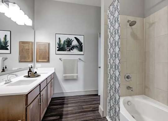 A bathroom with a white sink and a white bathtub.