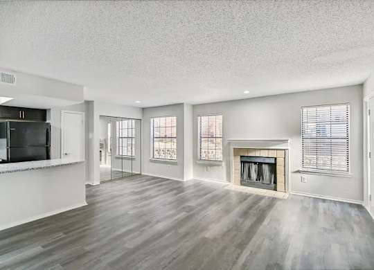 A spacious living room with a fireplace and sliding glass doors.