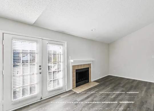 A room with a fireplace and a sliding door.