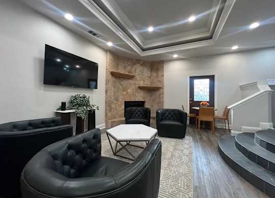 A living room with a fireplace and a television.