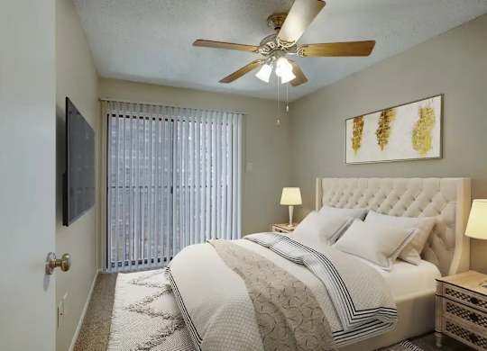 A bedroom with a large bed, a ceiling fan, and a painting on the wall.