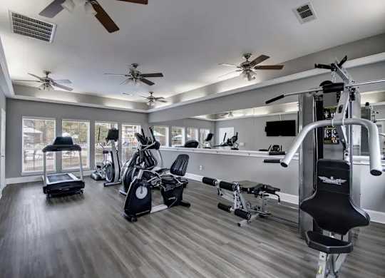 A spacious home gym with a variety of exercise equipment.