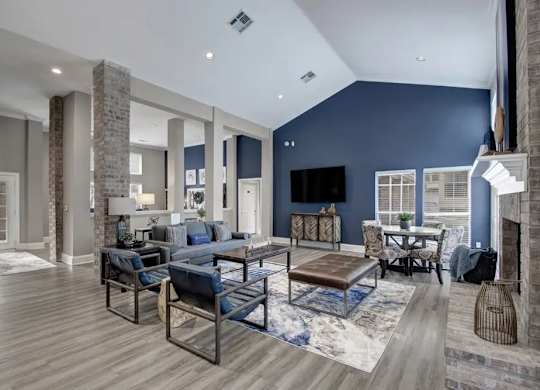 A modern living room with a fireplace and a blue accent wall.