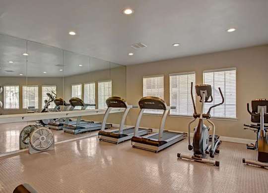 A spacious home gym with a variety of exercise equipment.