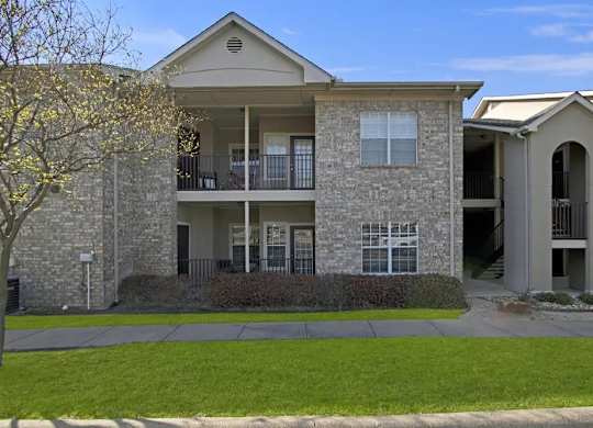 A two-story building with a balcony on the second floor.