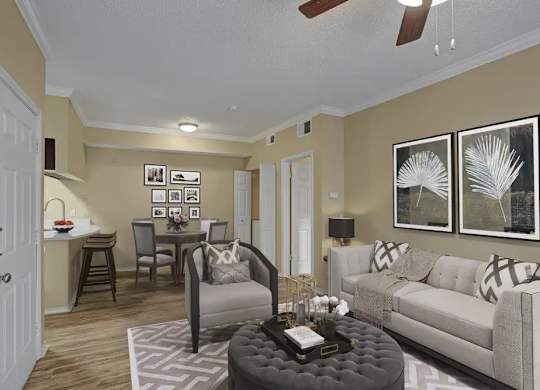 A living room with a grey ottoman and a white couch.