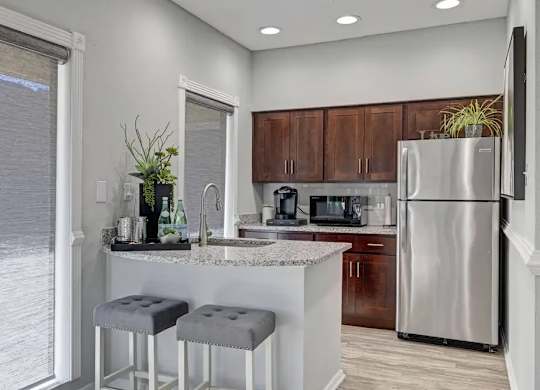 A kitchen with a bar stool and a counter.