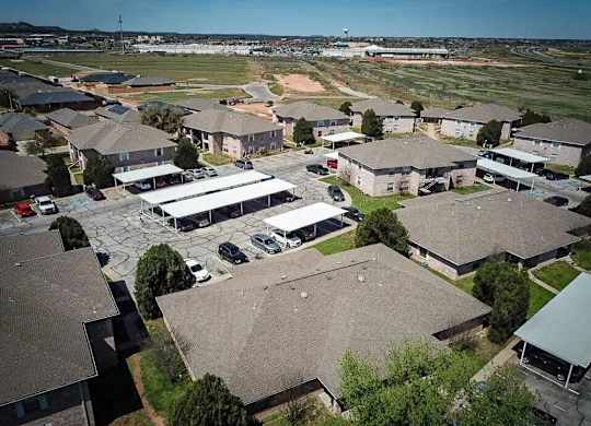 A bird's eye view of a residential area with houses and cars.