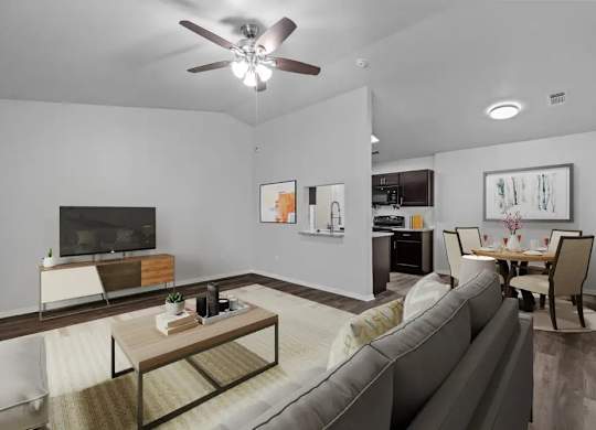 A living room with a grey couch, a wooden coffee table, and a ceiling fan.