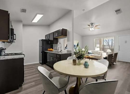 A modern kitchen with a dining table and chairs.