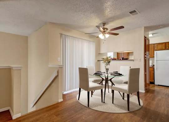 A dining room with a table set for six.