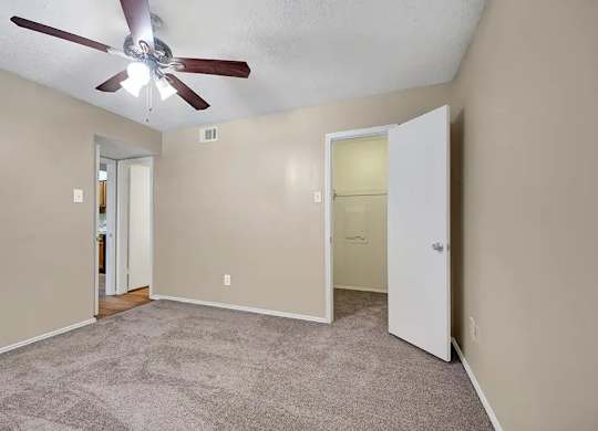 Bedroom with walk-in closet and attached bathroom at South Meadows Apartments, Red Oak, TX 75154