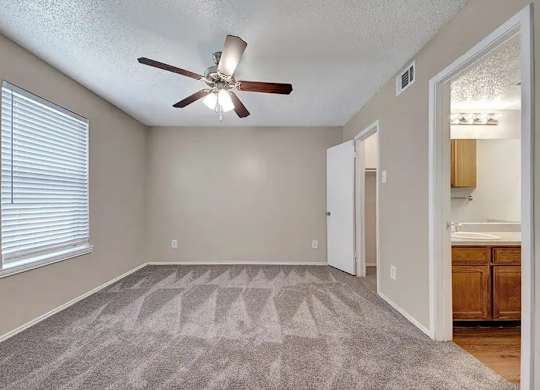 Vacant bedroom with en suite bathroom access at South Meadows Apartments, Red Oak, 75154