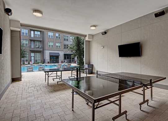 Poolside Outdoor Yard Game Area at Civic at Frisco Square Apartments, Frisco