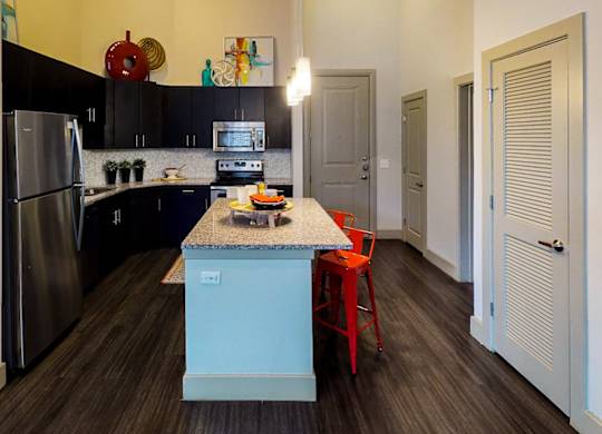 Kitchen with wooden closet at Civic at Frisco Square Apartments, Frisco, TX