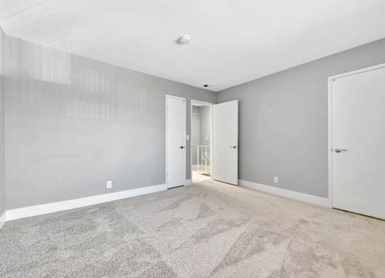 A room with grey walls and a carpeted floor.