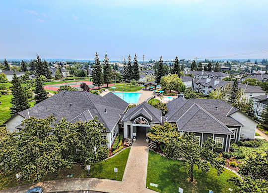 Aerial view of community clubhouse and pool area at Rosemeade Apartments, California