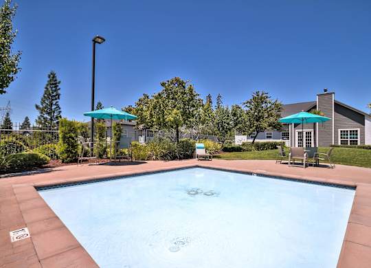 Community pool with spa jets and sundeck at Rosemeade Apartments, Roseville