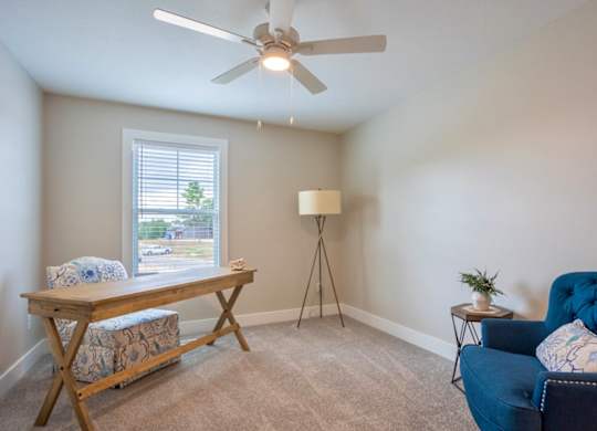 A room with a blue chair and a wooden table at Ventura Townhouses, West Olive  , 49460