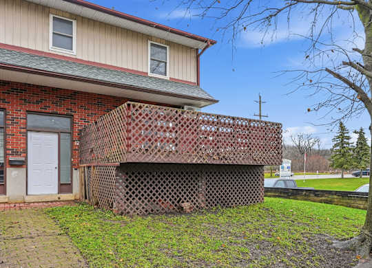 A house with a red brick exterior and a white door.