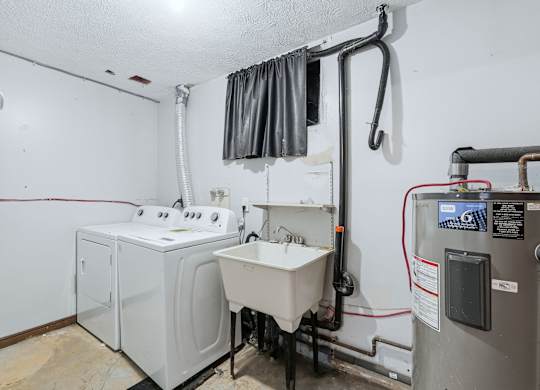 A bathroom with a washer and dryer.