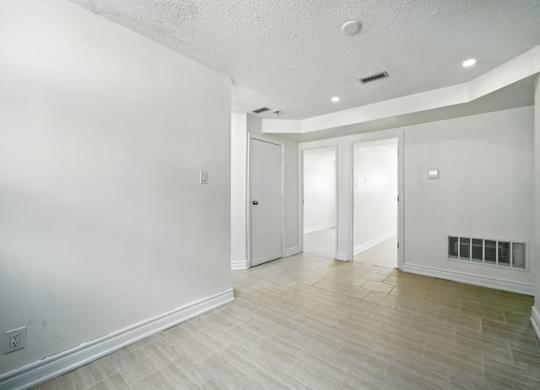 A room with white walls and a wooden floor.