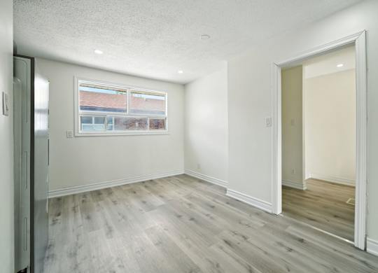 A room with a window and a door.