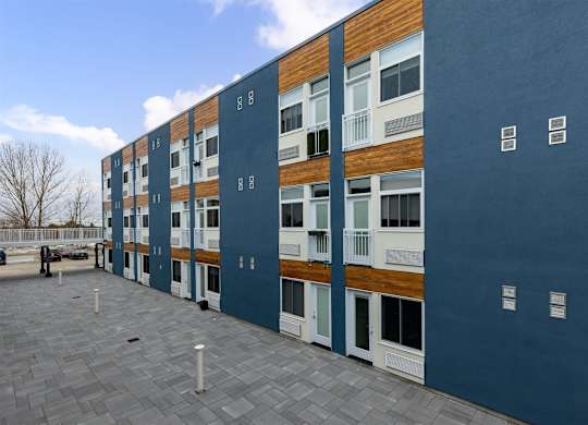 A modern building with a blue and brown facade.