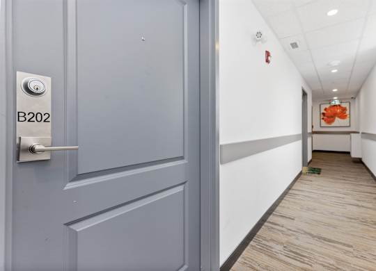 A hallway with a door labeled B202.