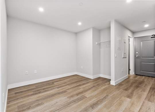 A room with a wooden floor and white walls.