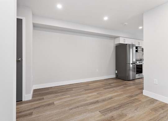 A kitchen area with a refrigerator and a dishwasher.