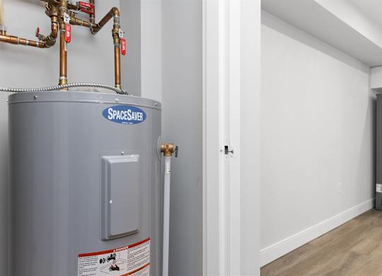 A grey water heater with the label