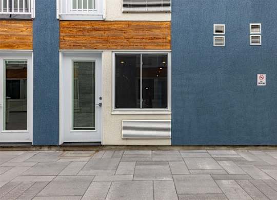 A building with a blue wall and a white door.