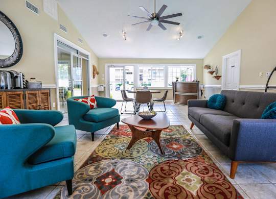 A living room with a grey couch and a blue chair.