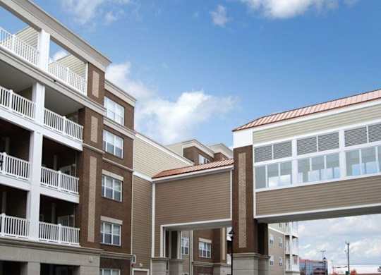 A modern apartment complex with brown and beige buildings.