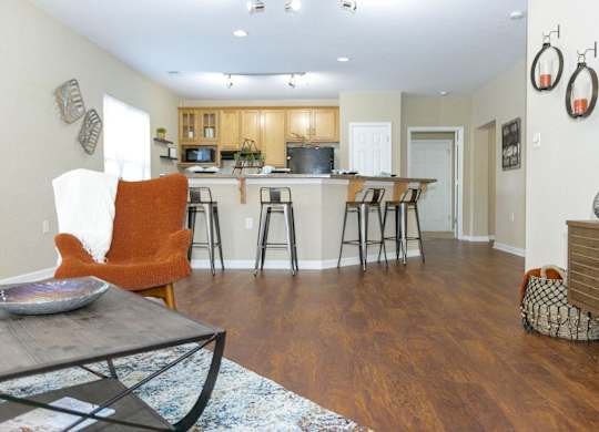 A kitchen with a dining table and chairs.