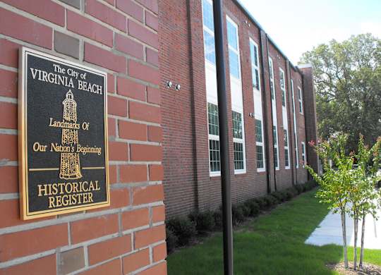 A sign on a brick wall that says "The City of Virginia Beach".
